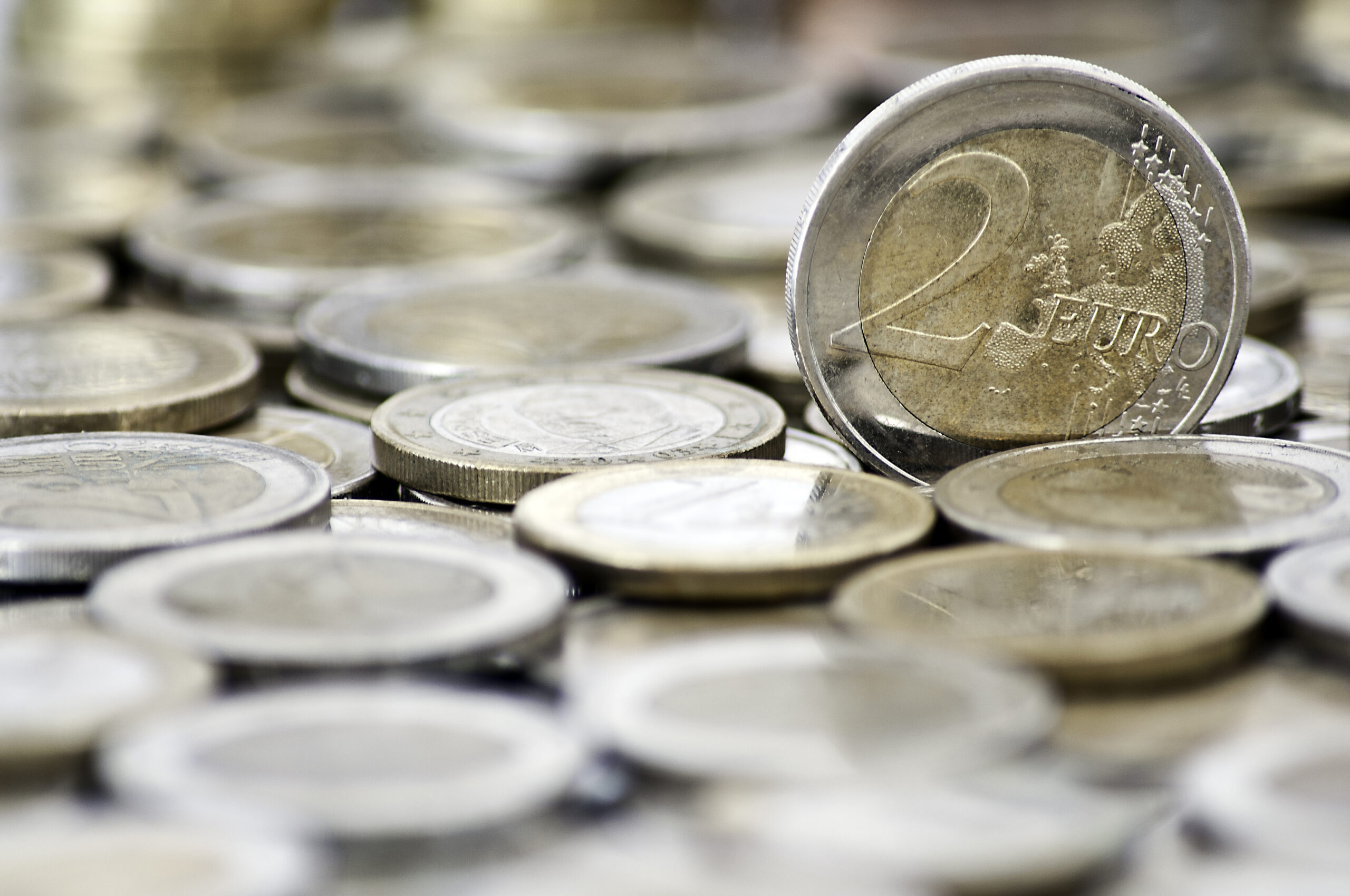 Grungy 2 euro coin with coins on background