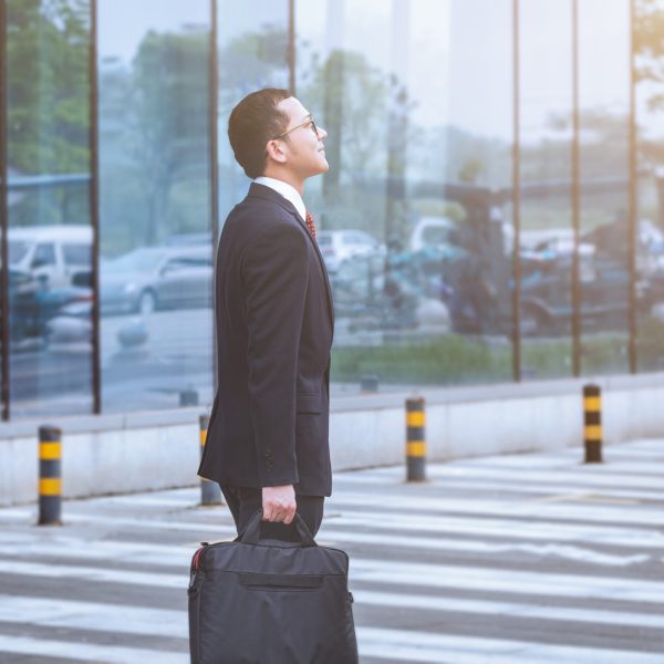 young businessman walking outside office