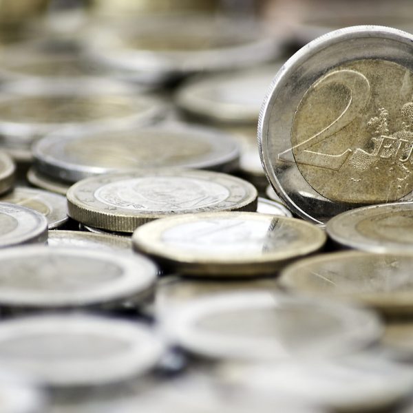 Grungy 2 euro coin with coins on background